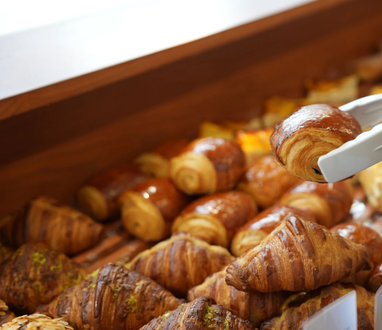Hand choosing a pastry from the tray